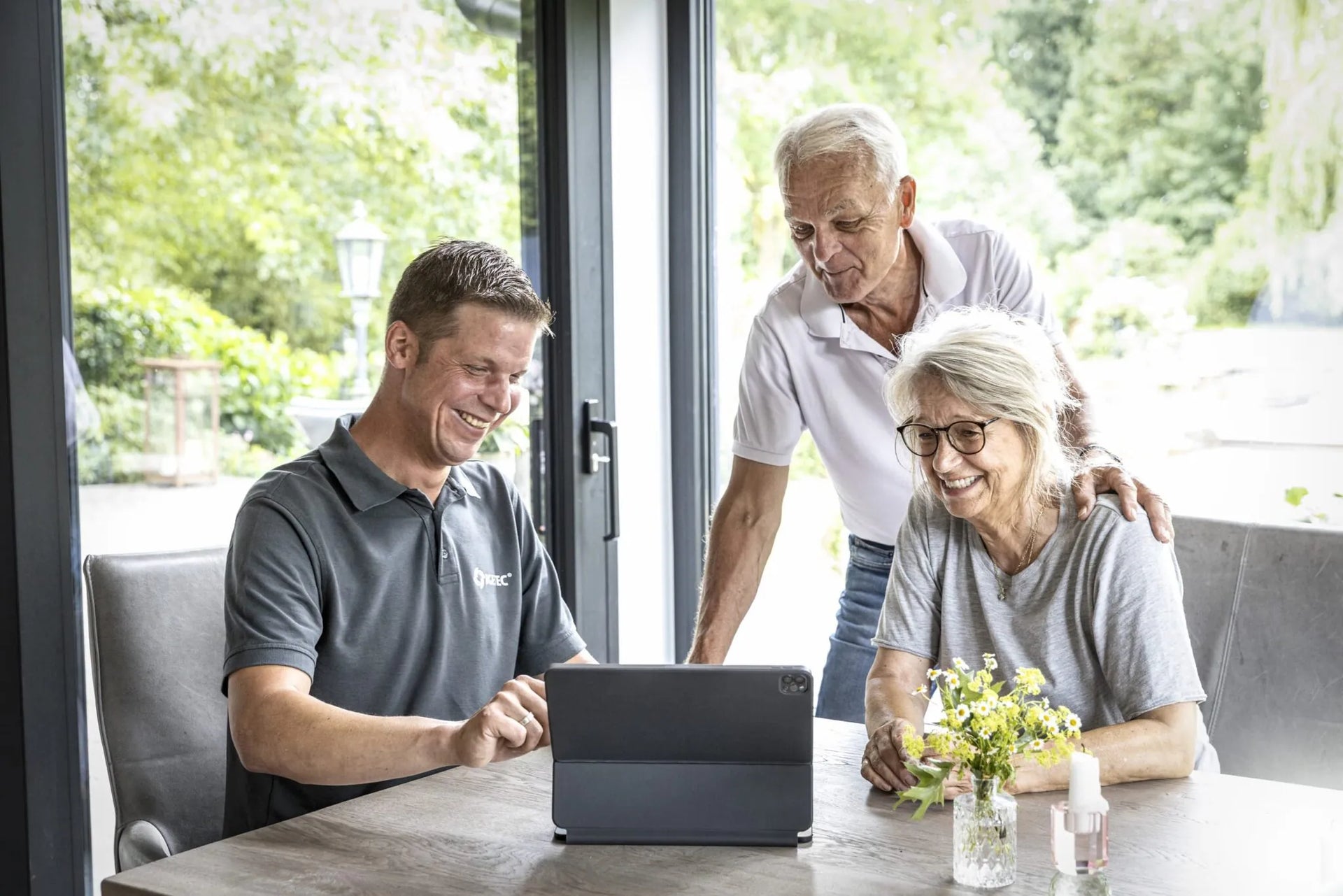 Beratungssituation mit IGETEC Energie- und Umwelttechnik: Ein Fachberater erläutert Bauherren am Tablet energieeffiziente Gebäudetechniklösungen für Wohn-, Gewerbe- und Industrieprojekte sowie innovative Wärmerückgewinnungssysteme